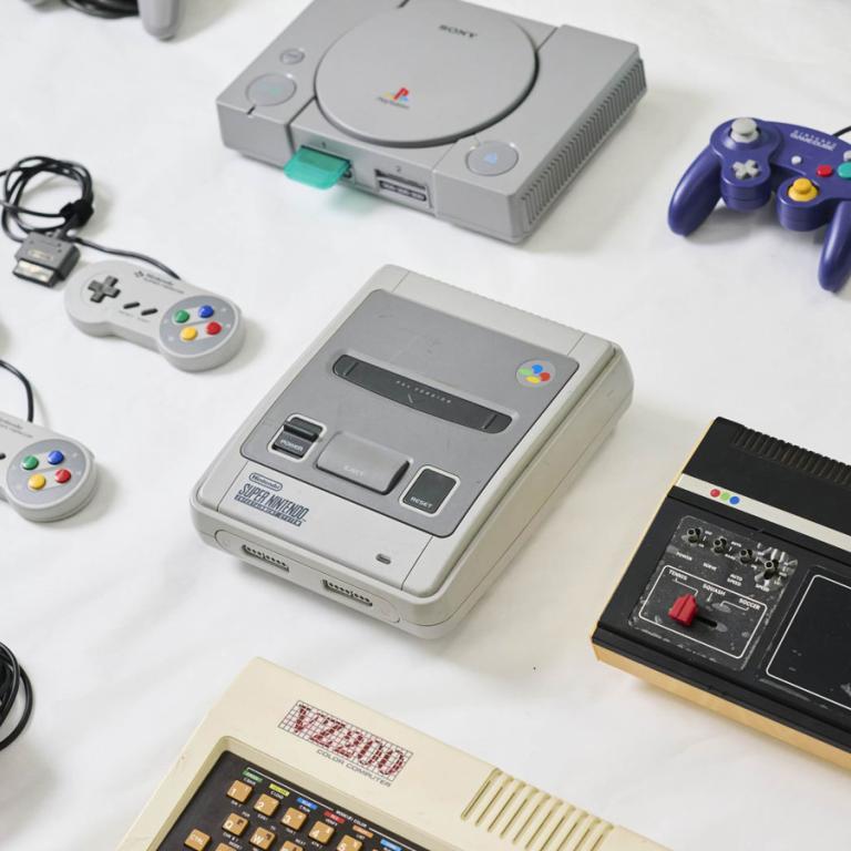 Video game consoles and hardware laid out on a table